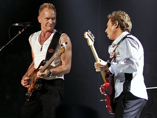 Lead singer and bassist Sting, left, looks over to guitar player Andy Summers during a performance by the band The Police in Vancouver.