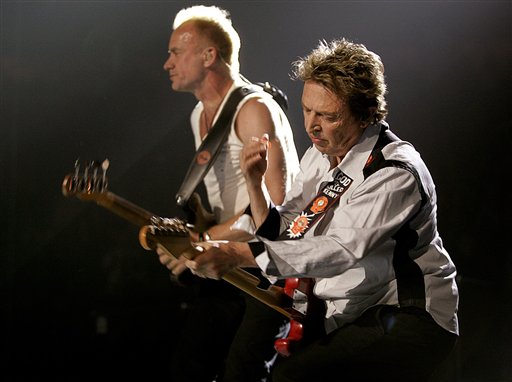 Guitartist Andy Sommers, right, of the band The Police performs along side leader singer and bassist Sting during a concert to begin their worldwide tour in Vancouver.