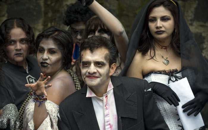 Mexicans dressed as zombies pose for photagraphers before a rehearsal and just before the start of the &quot;Thrill The World: A Global Tribute to Michael Jackson&quot; in Mexico City. Thrill the World is a worldwide attempt - taking place in more than 200 cities in 29 countries - to set a new Guinness World Record for the largest Thriller simultaneous dance. (Image: AFP)