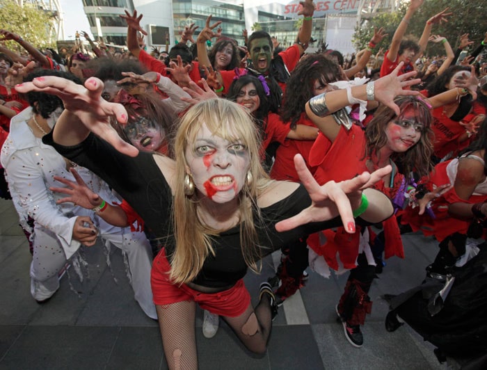 A costumed participant, among several hundred others, takes a photo while waiting to set a worldwide record for the most people dancing to the Michael Jackson hit, &quot;Thriller,&quot; at LA Live, across from Staples Center in downtown Los Angeles. (Image: AP)