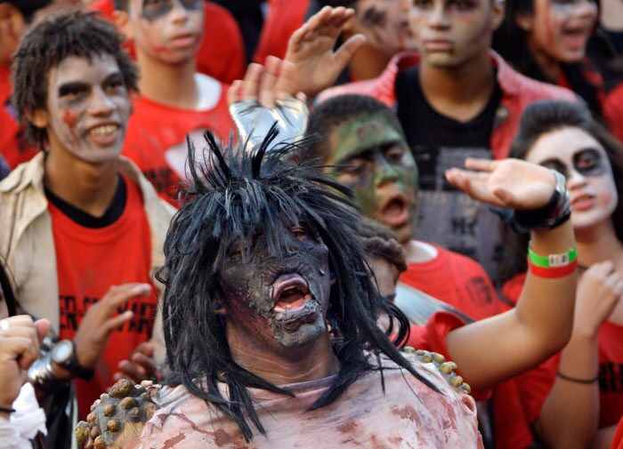 A costumed ghoul is among several hundred dancers hoping to set a worldwide record for the most people dancing simultaneously to the Michael Jackson hit, &quot;Thriller&quot;. (Image: AP)