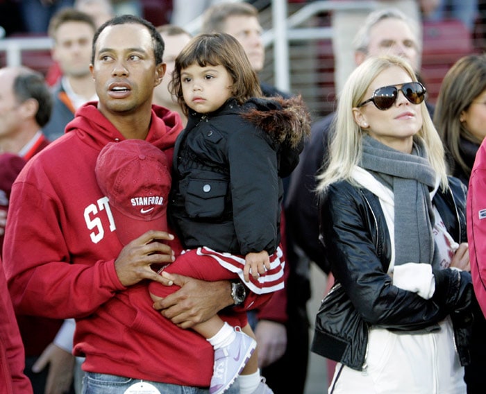 Woods receives multimillion-dollar fees for putting his signature on new golf courses and runs a world foundation aimed at getting more young, disadvantaged people out on the greens. In this Nov. 21, 2009 file photo, Tiger Woods with his daughter Sam and wife Elin are seen before the start of a NCAA college football game between Stanford and California in Stanford, Calif. (Text: IANS, Photo: AP)