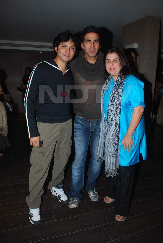 Shirish and Farah pose with the man who showed his belly button.