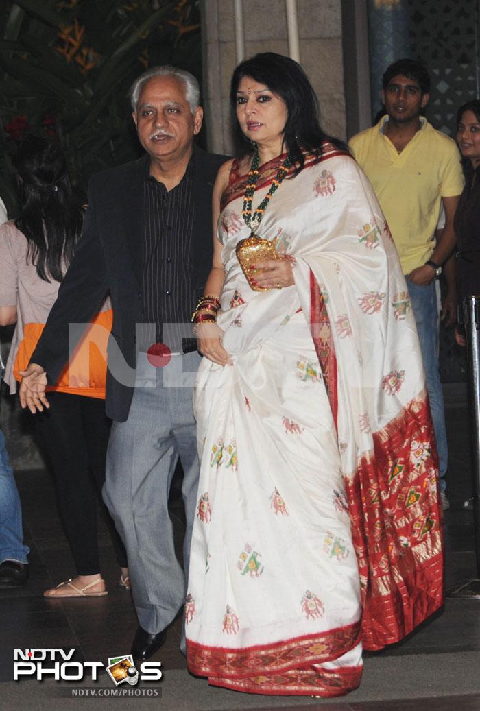 Ramesh Sippy and wife Kiran walk in together.