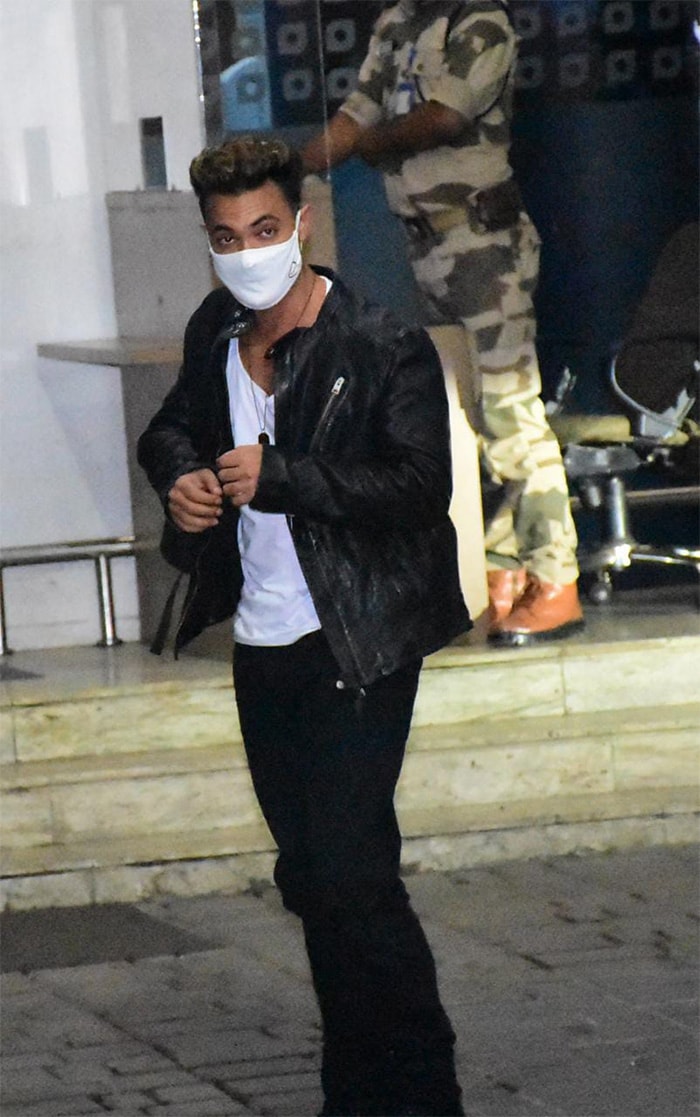 Aayush Sharma was pictured in a white tee, black jeans and a black jacket.  (Image credit: Varinder Chawla)