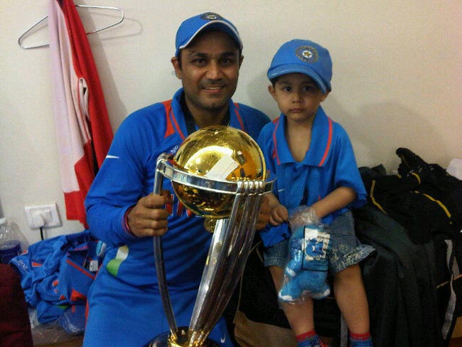 Sehwag shared a pic of him with his son Aryavir. While Sehwag is all but happy to hold the trophy, Aryavir is feeling the pressure already.