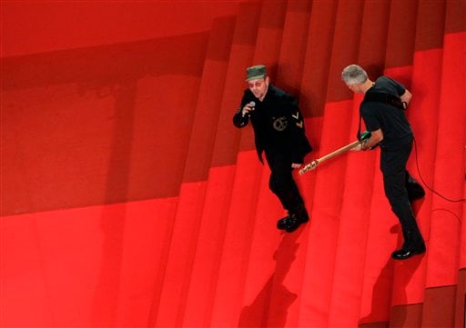 Irish musician Bono, left, and British musician Adam Clayton of U2 perform on the steps at the 60th International film festival in Cannes.