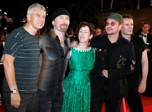 The members of U2, from left, Adam Clayton, The Edge, director Catherine Owens, Bono, and Larry Mullen Jr pose on the red carpet before the screening of the film U2 3D, at the 60th International film festival in Cannes.