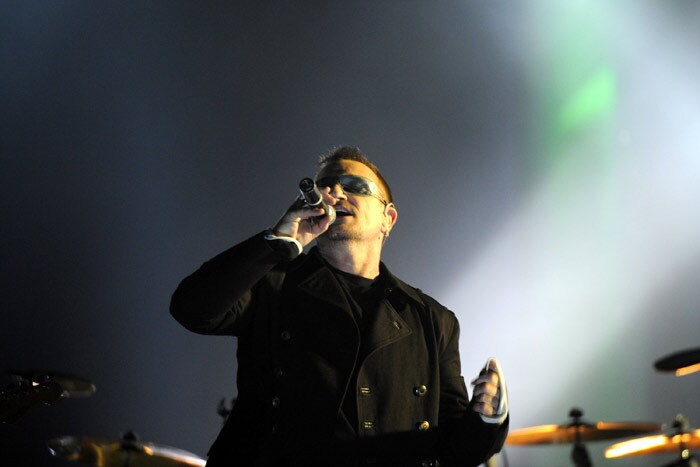 Bono, singer of the Irish rock band U2 performs on stage at the Brandenburg Gate in Berlin during a free open-air concert on November 5, 2009 as part of celebrations to mark the fall of the Berlin Wall 20 years ago. The concert will be aired live during the MTV European Music Awards also held in the German capital. (Photo: AFP)