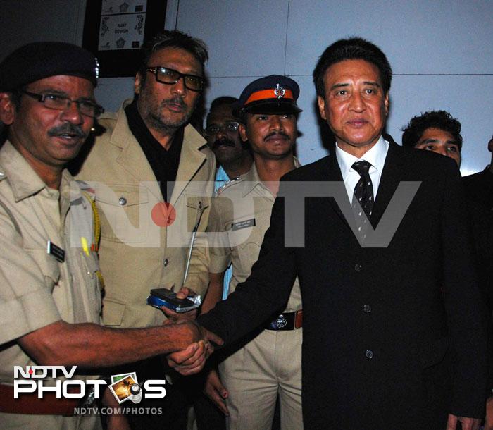 Danny Denzongpa shakes hands with a policeman. Jackie Shroff is seen in the background.