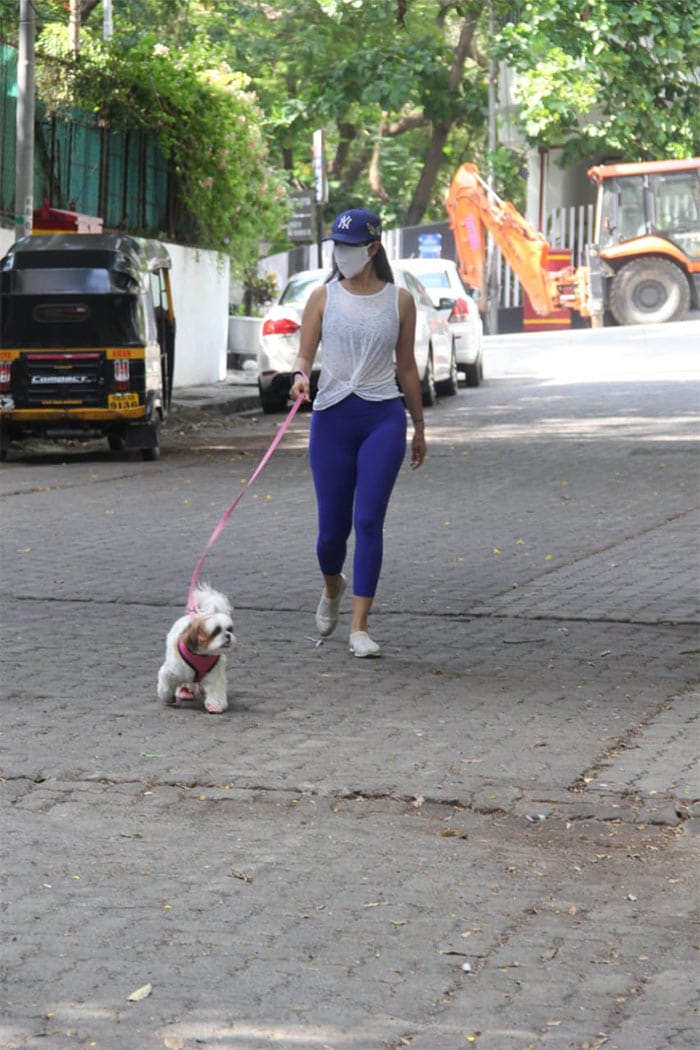 Sophie Choudry was photographed taking a walk with her pet pooch in Bandra.