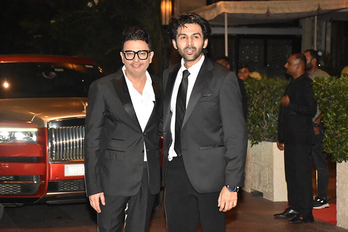 Kartik Aaryan posed with Bhushan Kumar outside the venue.