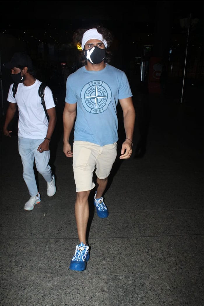 The actor kept his airport look casual in a blue T-shirt and fawn shorts.