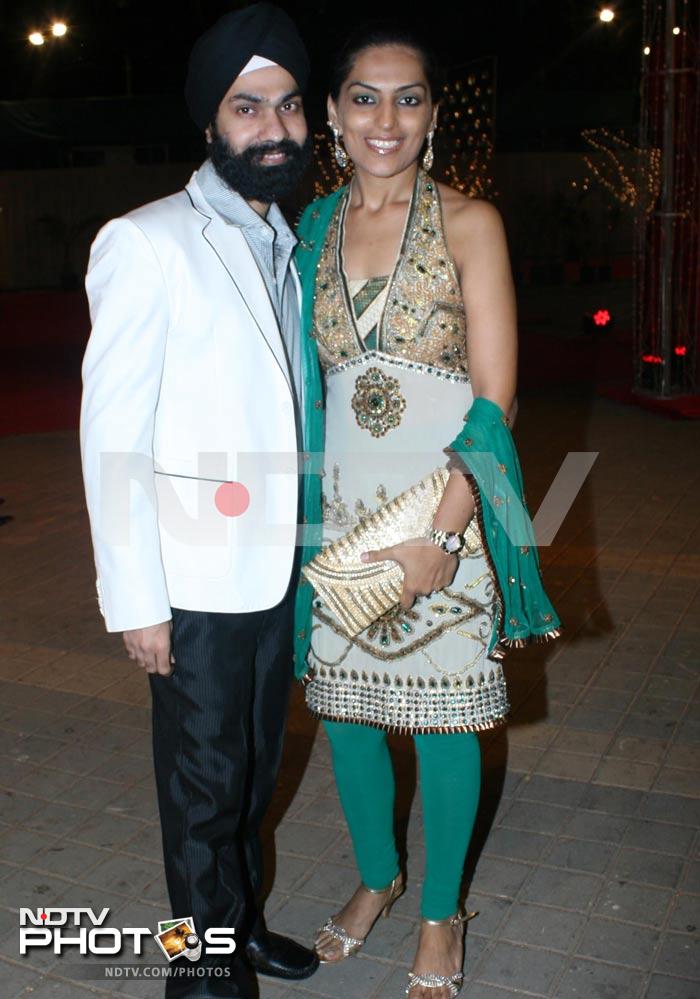 Designer AD Singh with his pretty wife, who is wearing a green and white halter churidar suit.