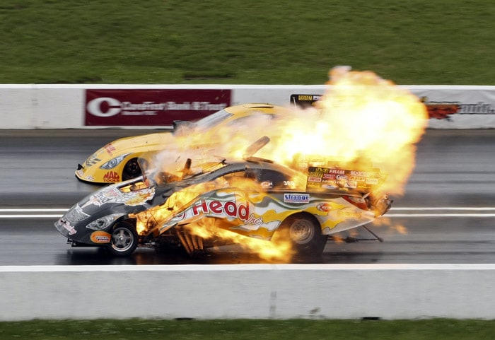 In a photo provided by the NHRA, fire shoots from Jim Head's Funny Car after an explosion in a semifinal against Jeff Arend in the NHRA Summer Nationals drag races on Sunday, May 23, 2010, at Heartland Park in Topeka, Kan. Head lost the round to Arend, but both Head and Arend were unharmed in the explosion. (Photo: AP)