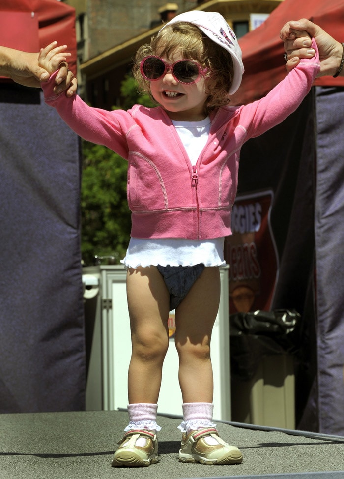 A toddler shows off the new Huggies Little Movers Jeans Diapers during the 'What's Your Denim Style' baby fashion show in Union Square on May 20, 2010. The all-new jeans design by Huggies are the new look for summer. (Photo: AFP)