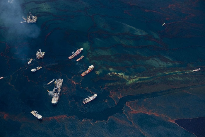 This picture released by Greenpeace on May 19, 2010 shows an aerial view vesels passing through leaking oil from the Deepwater Horizon wellhead off the Louisiana coast. BP said that a tube inserted into a ruptured oil pipe now is sucking up about 40 per cent of the crude spewing into the Gulf of Mexico, about twice as much as it did one day earlier. The company said in a statement that its 'riser insertion tube tool' is estimated to be collecting and carrying about 2,000 barrels a day of oil to flow up to the drillship Discoverer Enterprise on the surface 5,000 feet above. (Photo: AFP/Greenpeace)