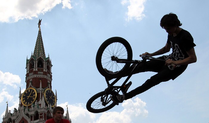 A cyclist jumps during a perfomance on Red Square in Moscow on May 23, 2010. (Photo: AFP)