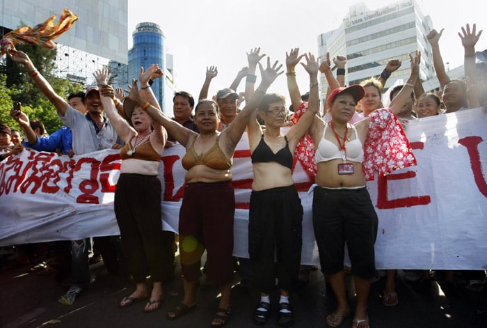 Anti-government protesters take to a street half dressed to prove that they are unarmed on Tuesday, May 18, 2010 in Bangkok, Thailand. The Thai government rejected a proposal on Tuesday for peace talks with leaders of the Red Shirt protesters to end the deadly mayhem gripping Bangkok, saying negotiations cannot start until the protesters disperse. (Photo: AP)