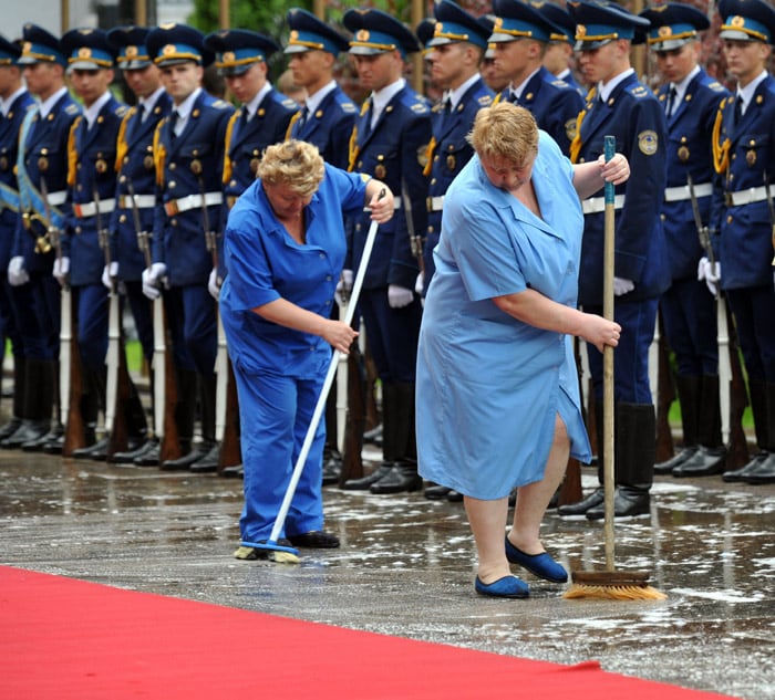 Cleaners clean carpet after heavy rain prior to a ceremony of the meeting Ukrainie's President Viktor Yanukovych and his Russian counterpart Dmitry Medvedev in Kiev on May 17, 2010. Medvedev arrived in Ukraine for a two-day official visit. (Photo: AFP)