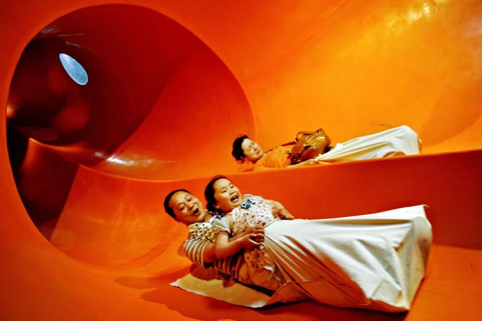 Visitors enjoy a slide inside the Swedish pavilion at the site of the World Expo 2010 in Shanghai on May 18, 2010. Organisers expect 70 million visitors -- most of them Chinese -- to attend the biggest-ever World's Fair, with an average of 380,000 people expected to visit the site daily. (Photo: AFP)