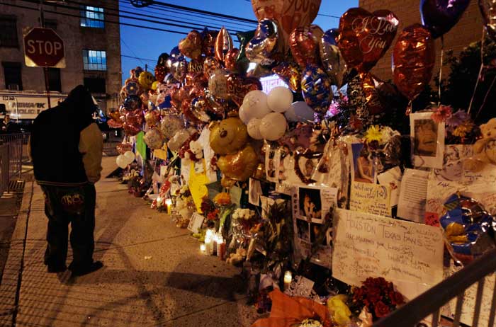 A person stops at a memorial to Whitney Houston outside New Hope Baptist Church in Newark, N.J.