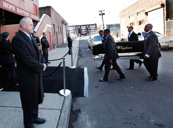 A coffin holding the remains of singer Whitney Houston is carried into the New Hope Baptist Church before funeral services.