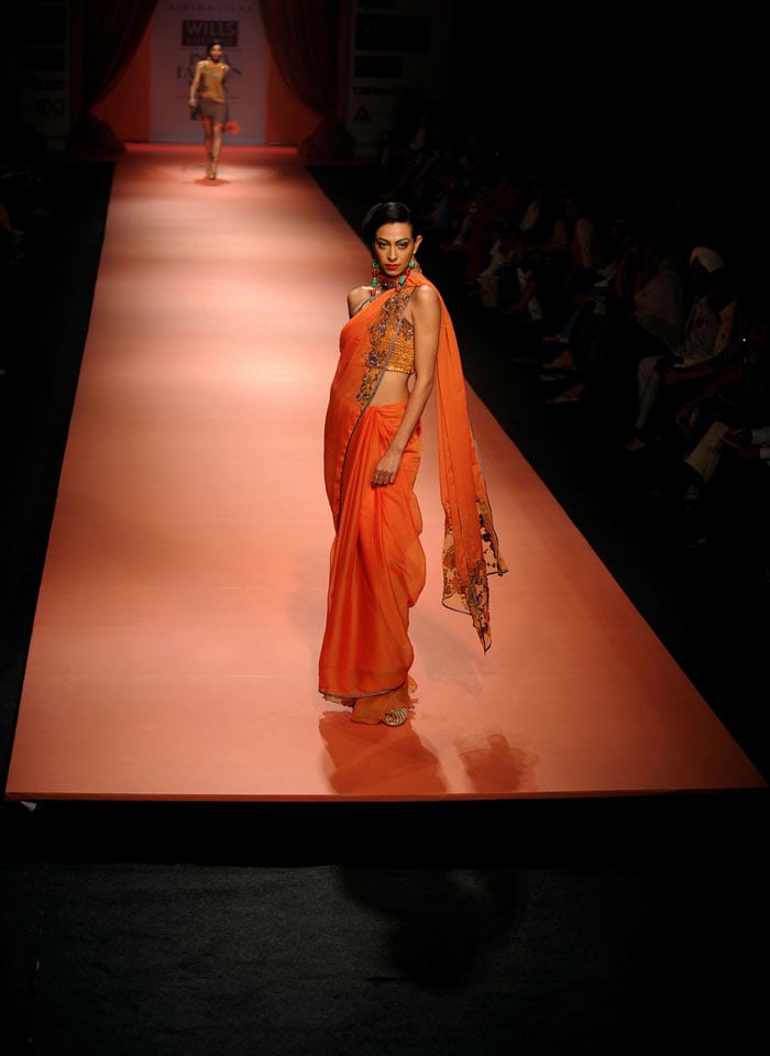 A model presents a creation by designers Ashima-Leena during the Wills India Fashion Week Autumn-Winter 2010 in New Delhi on March 25, 2010. India's leading fashion week event opened March 25 after a missing fire permit forced the cancellation of all shows on the first day. (Photos: AFP)