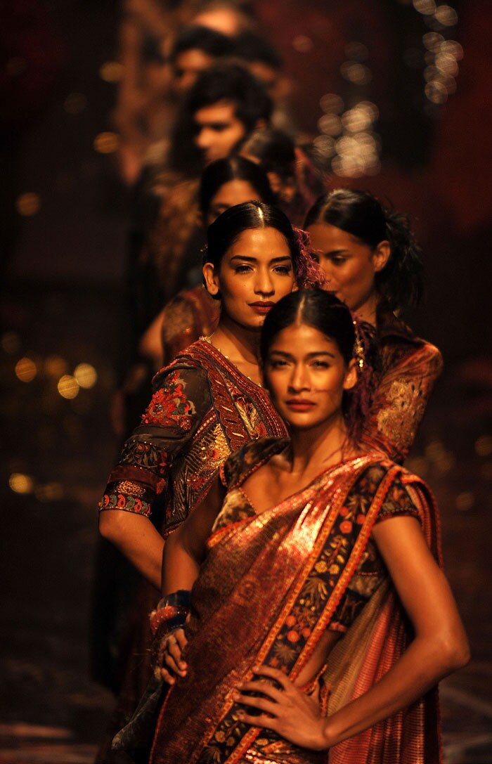 A day after a complete no-show on the first day of the Wills Lifestyle India Fashion Week due to lack of a fire safety permit, the event finally kicked off Thursday, managing to get all the approvals. Here's a look... <bR><bR> Models present creations by Indian designer Tarun Tahiliani during the Wills India Fashion Week in New Delhi on March 25, 2010. India's leading fashion week event opened March 25 after a missing fire permit forced the cancellation of all shows on the first day.