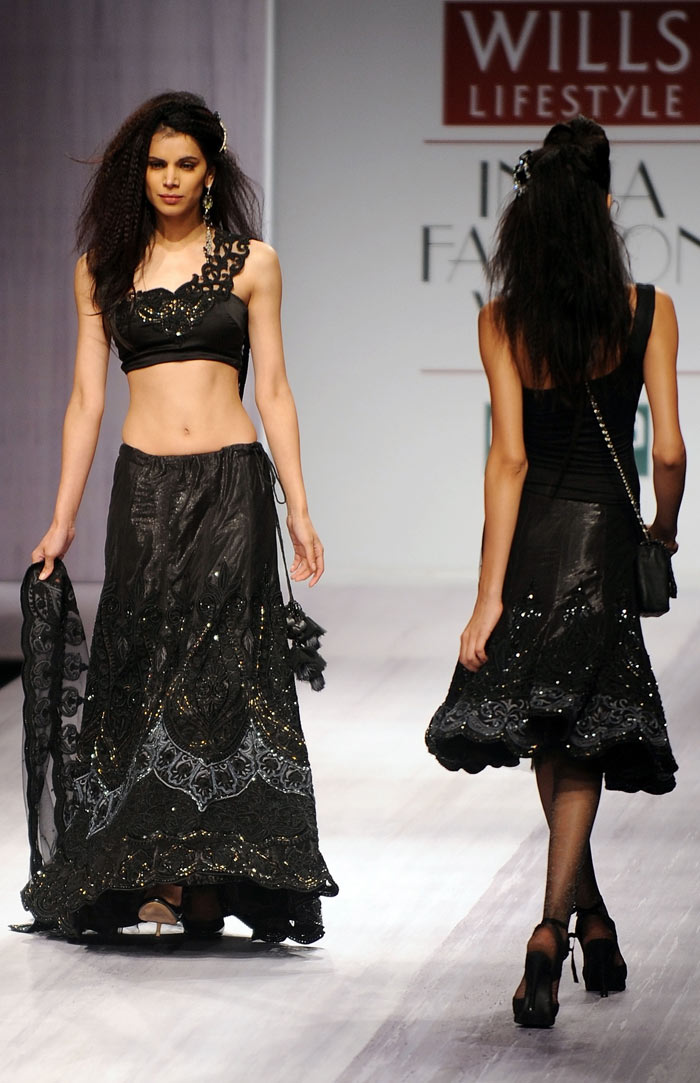 Models present creations by designer Kavita Bhartia during the Wills India Fashion Week Autumn-Winter 2010 in New Delhi on March 25, 2010. India's leading fashion week event opened March 25, after a missing fire permit forced the cancellation of all shows on the first day. (Photos: AFP)