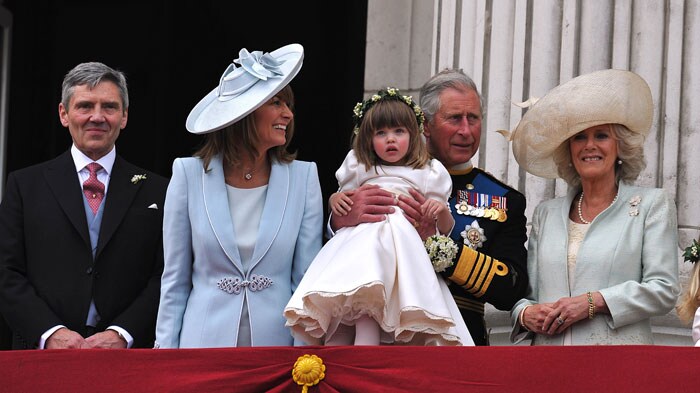 The family watch the kiss: Michael Middleton, Carole Middleton, Prince Charles holding up flower girl Eliza Lopes and Camilla, the Duchess of Cornwall