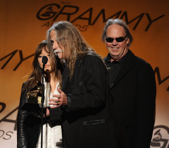 (L-R) Jenice Heo, Gary Burden and Neil Young with the Best Boxed or Special Limited Edition Package award for Neil Young Archives Vol. I (1963-1972) during the Pre-Telecast award presentations at the 52nd Grammy Awards in Los Angeles on January 31, 2010. (Photo: AFP)