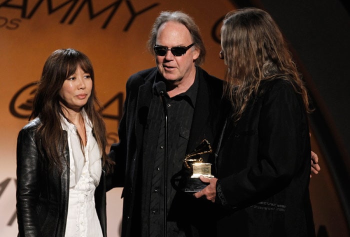 Jenice Heo, left, Neil Young, center, and Gary Burden accept the award for best boxed or limited edition for "Neil Young Archives Vol. 1" at the Grammy Awards on Sunday, Jan. 31, 2010, in Los Angeles. (Photo: AP)