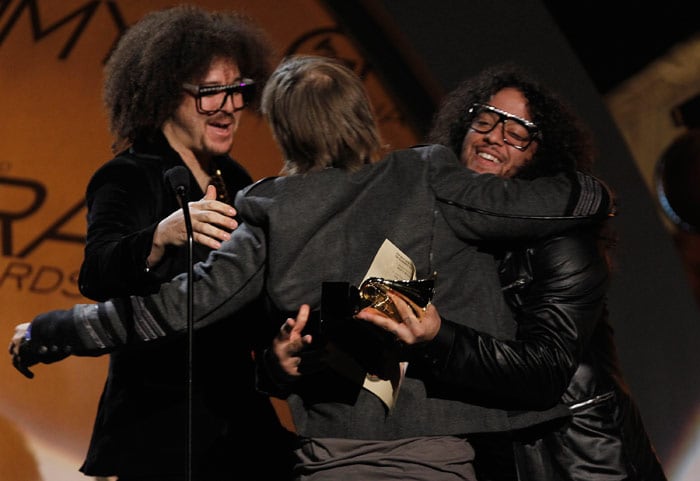 LMFAO present David Guetta, center, with the award for best remixed recording non-classical album for "When Love Takes Over" at the Grammy Awards on Sunday, Jan. 31, 2010, in Los Angeles. (Photo: AP)