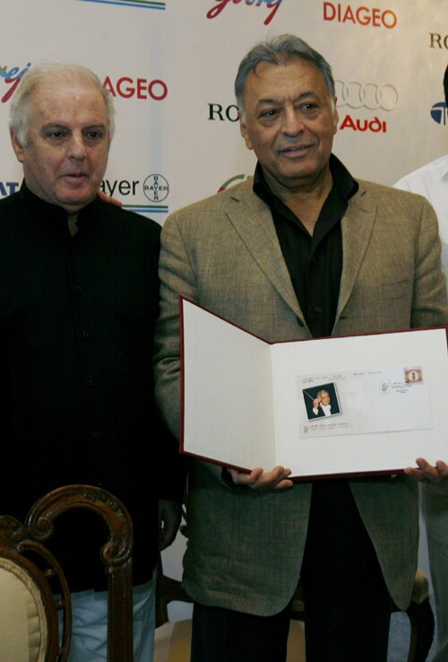 <b>Stamp!</b>: Zubin Mehta, right, holds a postage stamp of his father Mehli Mehta, that was released today as conductor and pianist Daniel Barenboim looks on during a press conference in Mumbai, India.