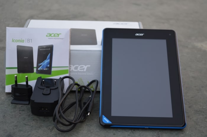 The accessories bundled with the tablet include a charger and a USB cable.