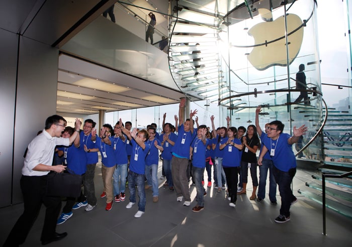 Customer cheers with staff members of Apple as the Apple store in Hong Kong started selling iPhone 5.