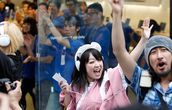Customers celebrate as Apple started selling iPhone 5 at a store in Tokyo.