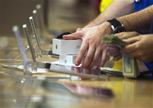 A customer picking up his Apple iPhone 5 phones at the Apple Store on 5th Avenue in New York.