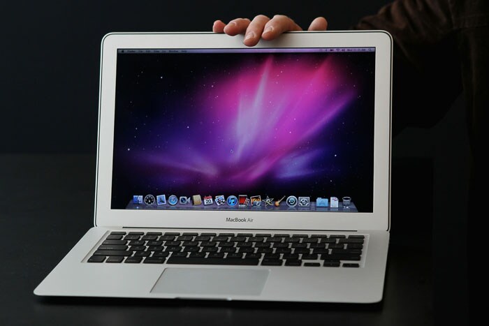 An Apple employee displays the new MacBook Air during an Apple special event at the company's headquarters in Cupertino, California. Apple CEO Steve Jobs announced the new MacBook Air in eleven and thirteen inch models starting at $999. He also announced the OSX Lion operating system for Mac computers. (Photo AFP)