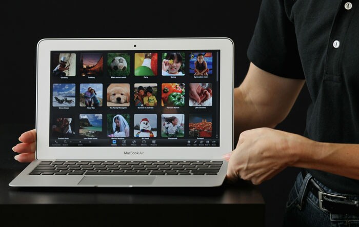 An Apple employee displays the new MacBook Air during an Apple special event at the company's headquarters in Cupertino, California. Apple CEO Steve Jobs announced the new MacBook Air in eleven and thirteen inch models starting at $999. He also announced the OSX Lion operating system for Mac computers.(Photo AFP)