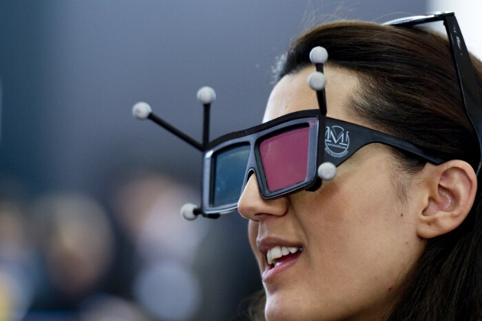 A woman wears 3D glasses. (Photo: AFP)
