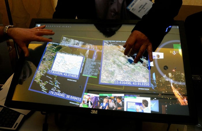 Vendors demonstrate a 3M Touch Systems Inc. 32-inch, multi-touch display during a press event at the Venetian for the 2011 International Consumer Electronics Show. The display can handle up to 60 touch inputs at once and can be used with anything that runs on Windows 7.