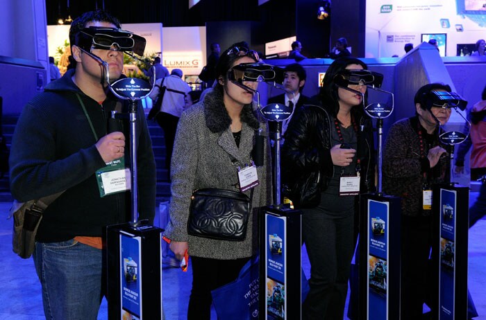 Convention attendees try out Panasonic's active shutter 3-D glasses at the CES 2011.