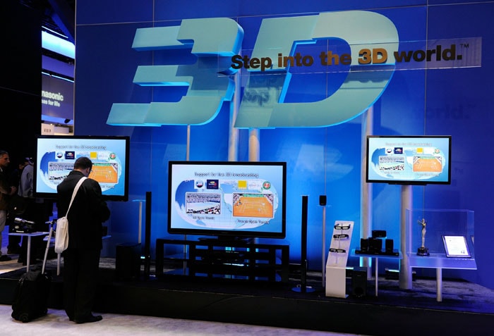 A convention attendee looks at 3-D televisions at the Panasonic booth at CES 2011.