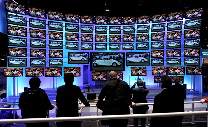 Convention attendees watch a presentation on Panasonic 3-D televisions at the CES 2011.