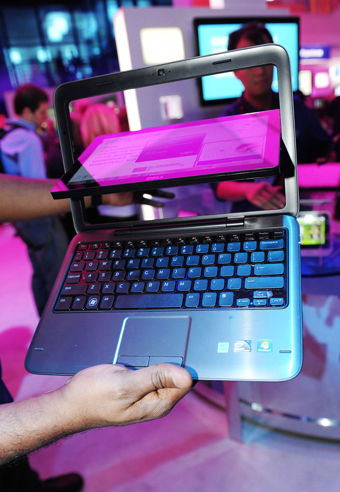 The Dell Inspiron Duo with touch-sensitive screen is on display at the CES 2011. The Duo's flip hinge design allows the user to switch between using the device as a traditional laptop or as a touch screen tablet.