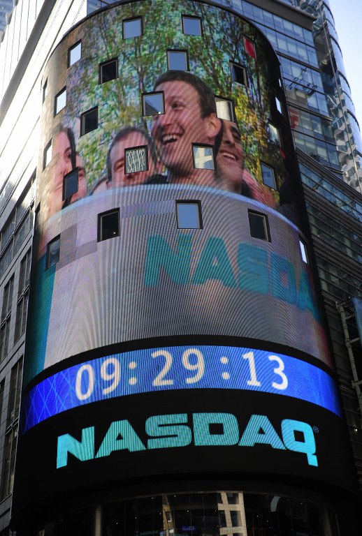 Facebook co-founder Mark Zukerberg is seen on a screen getting ready to ring the Nasdaq stock exchange opening bell in Times Square in New York