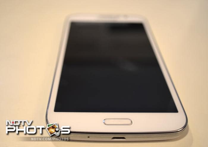 The phone has a physical Home button and its micro-USB port is located at the bottom.