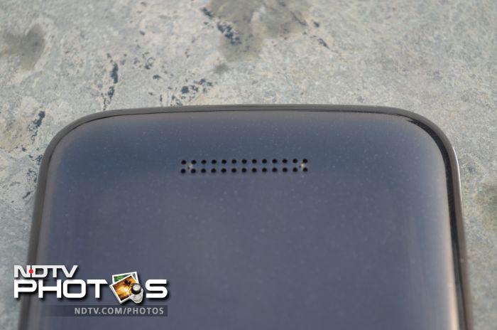 The speaker outlet is located towards the lower part of the phone's back.